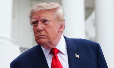 President Donald Trump speaks to members of the media as he departs the White House on October 10.