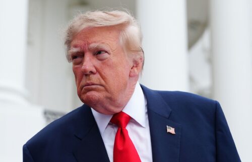 President Donald Trump speaks to members of the media as he departs the White House on October 10.