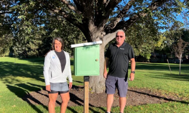 Mathesons standing near the THIRD little free library, despite it being vandalized multiple times at Reinhart Park in Idaho Falls