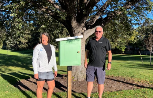Mathesons standing near the THIRD little free library, despite it being vandalized multiple times at Reinhart Park in Idaho Falls