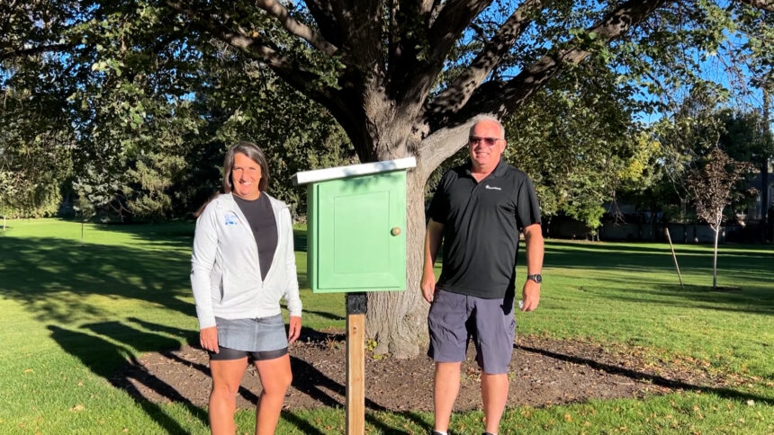 Mathesons standing near the THIRD little free library, despite it being vandalized multiple times at Reinhart Park in Idaho Falls